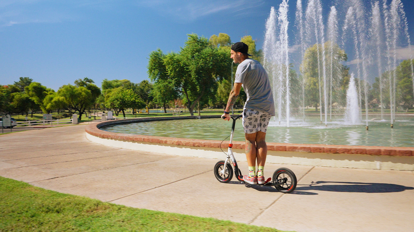 Adult Riding Madd Gear Urban Glide 5 Scooter Outdoors – Stylish Commute in City Setting