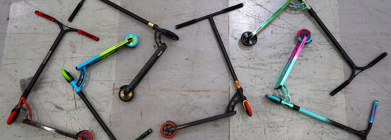 Madd Gear Pro Stunt Trick Scooters scattered on the ground.